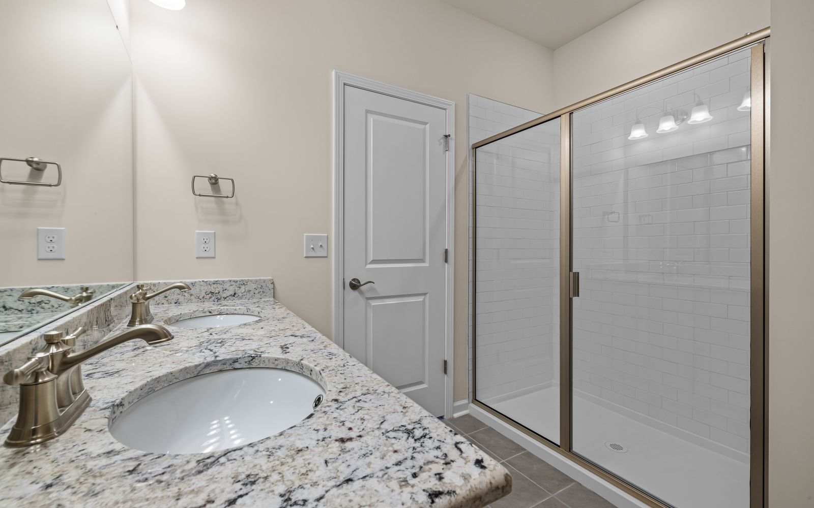 Walk-in shower in a modern stone-tiled bathroom