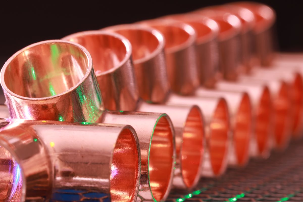 Polished copper plumbing fittings lined up
